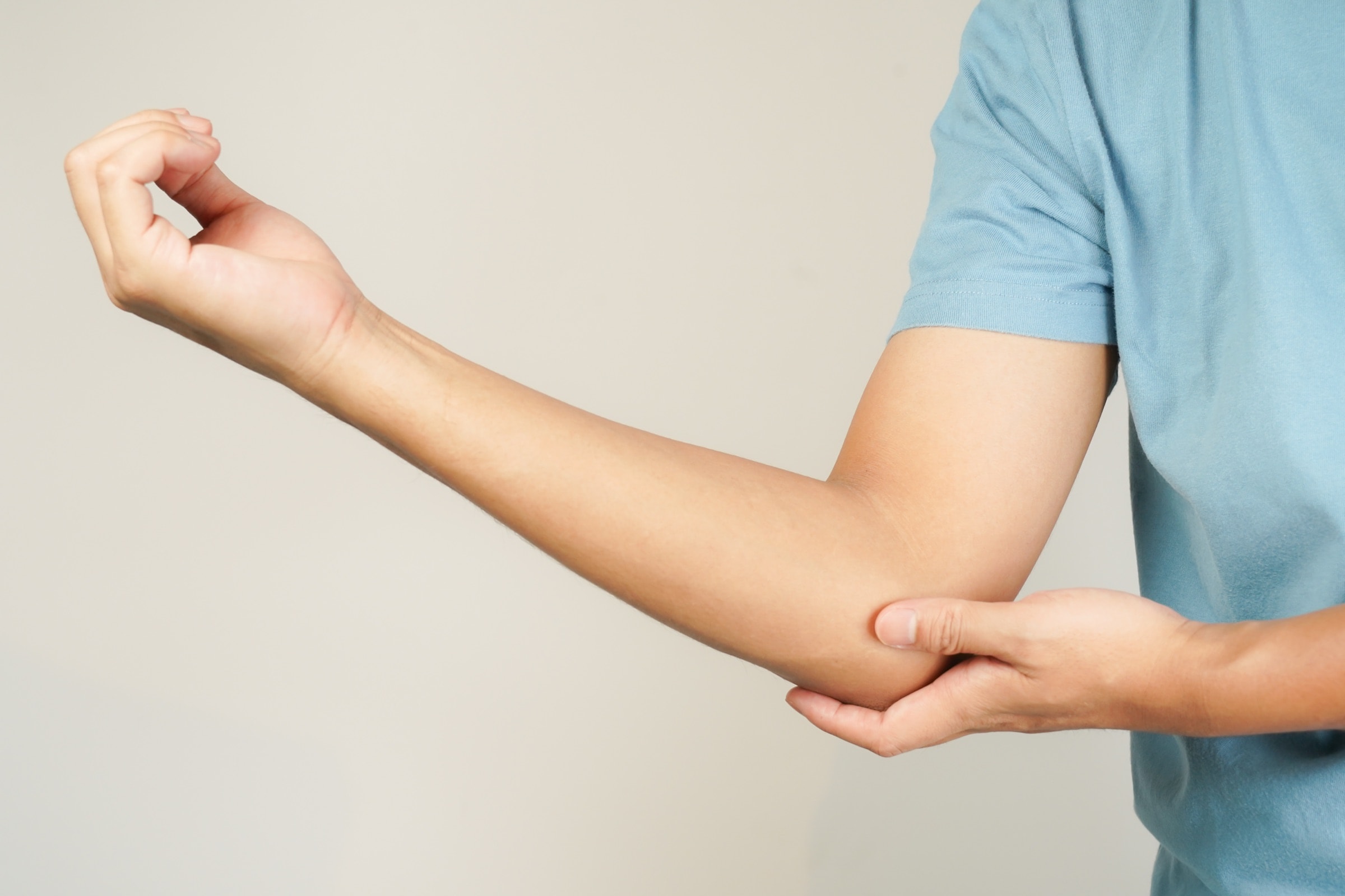 A man holding his sore elbow