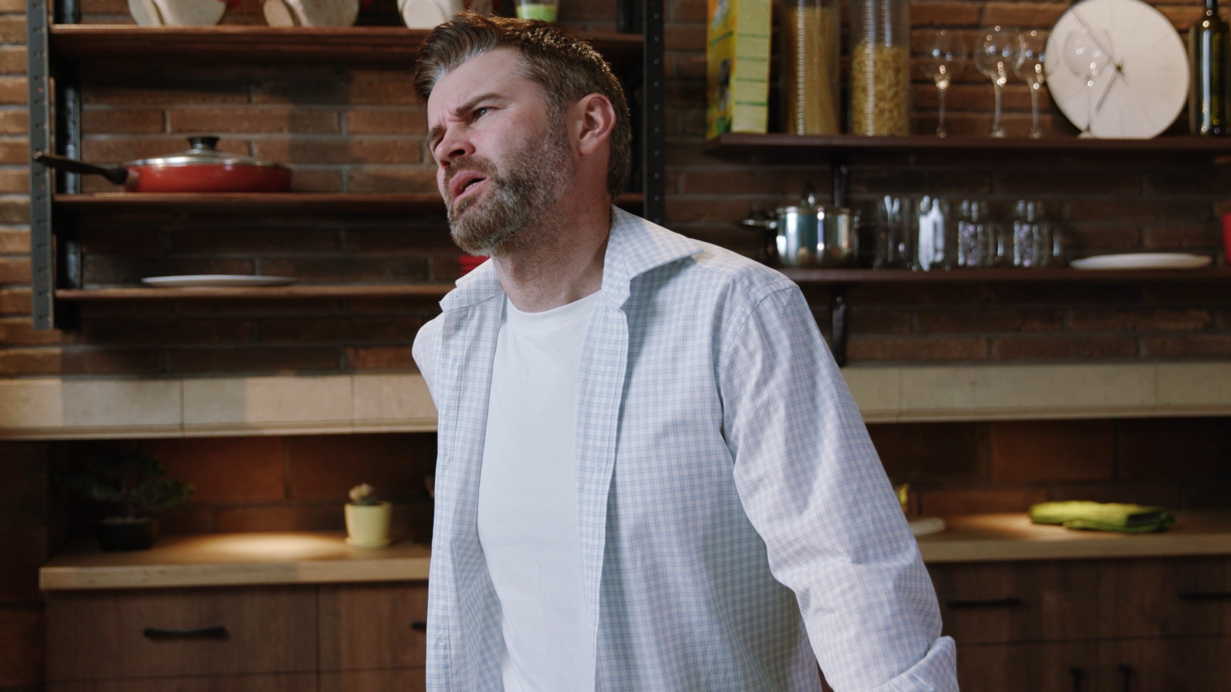 Man at home wincing from lower back pain