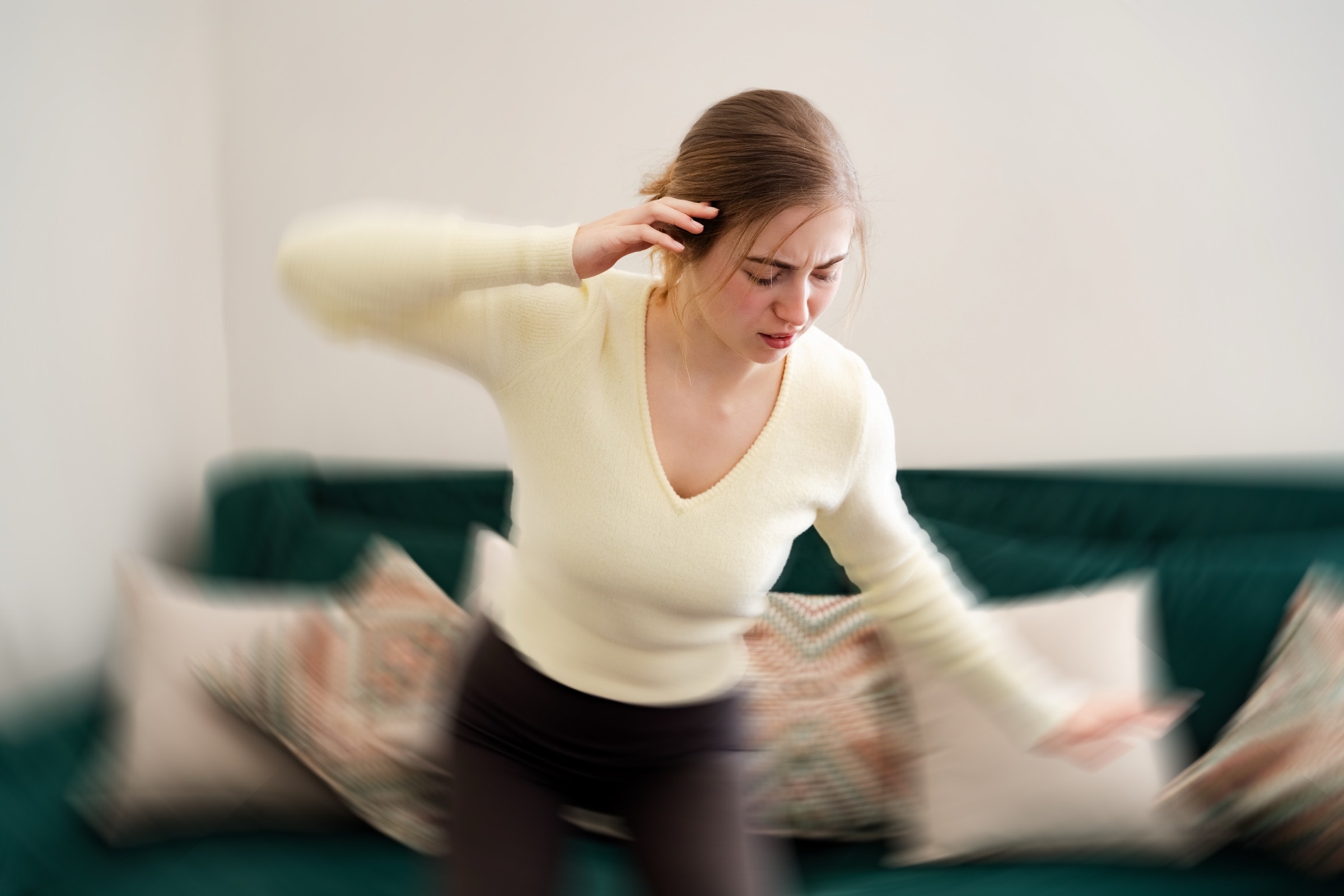 Woman feeling dizzy in her living room